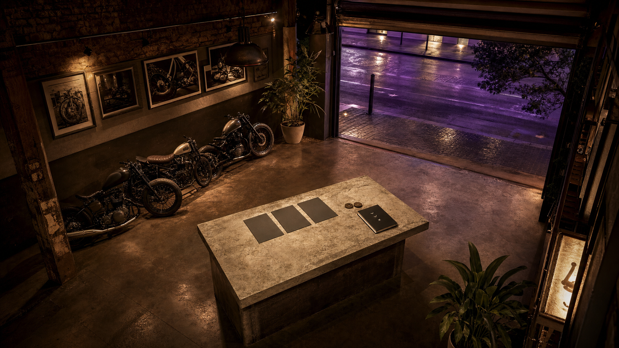 High-angle view of a Sydney motorcycle café garage with three comparison cards on a central table.